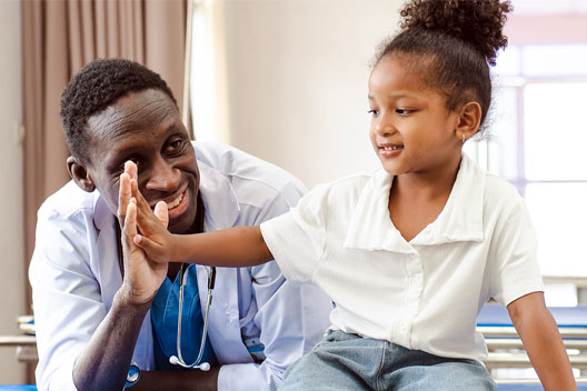 a kid giving a high five to a medical professional