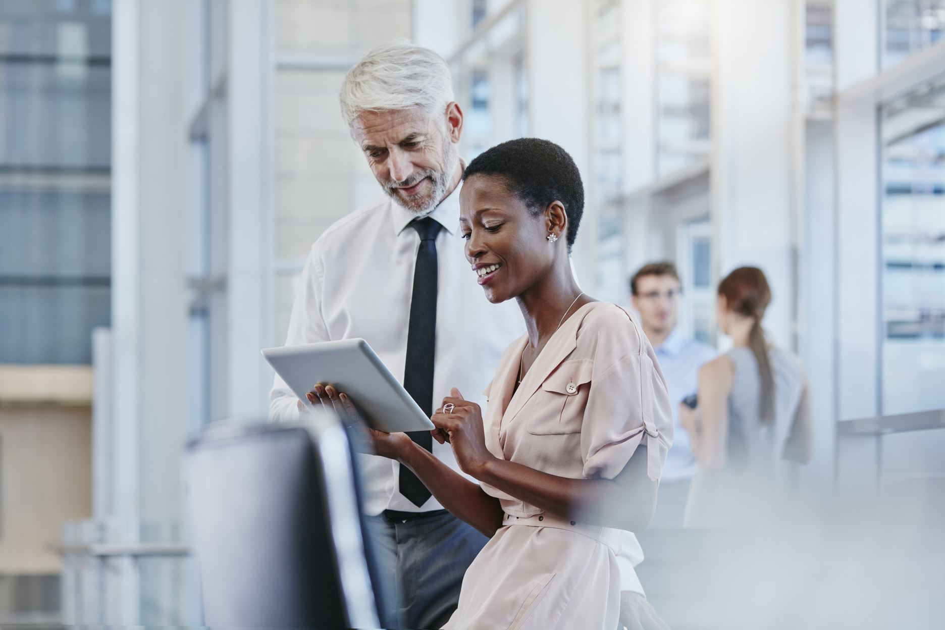 two people looking at a tablet
