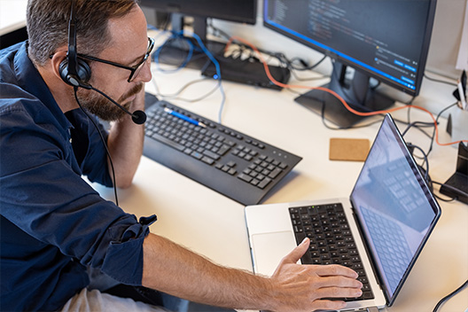 Man working while using a headphone