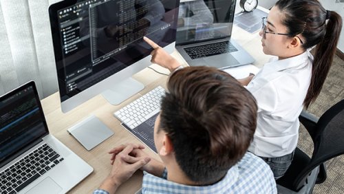 Woman next to a man pointing to the screen