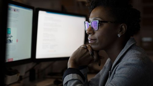 Woman with glasses with her hand on her cheek 