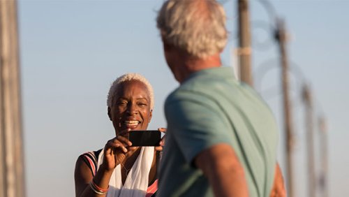 Woman taking a picture to a man